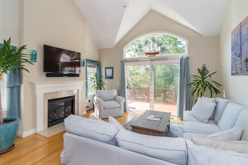 28 Prestwick Road, Unit 188 Bourne, MA 02532 - Photo 15 of 41 a living room with furniture a large window and a fireplace