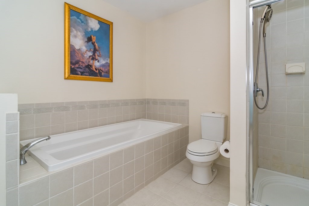 28 Prestwick Road, Unit 188 Bourne, MA 02532 - Photo 19 of 41 a white bath tub sitting next to a white toilet