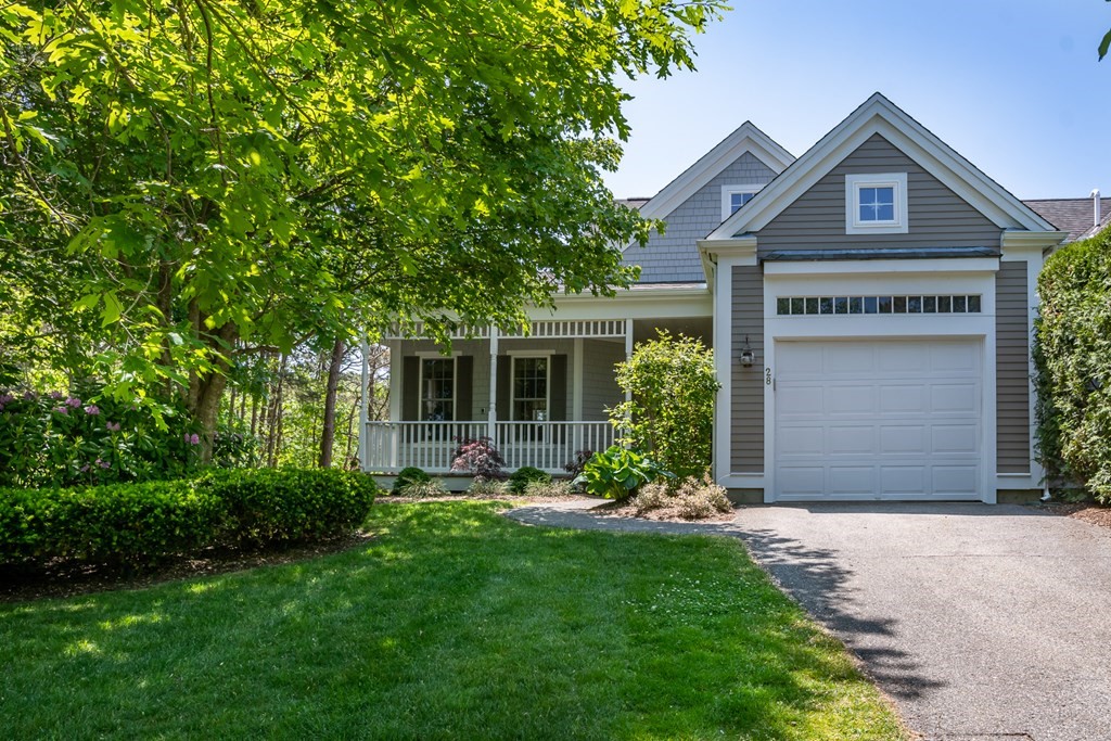 28 Prestwick Road, Unit 188 Bourne, MA 02532 - Photo 2 of 41 a front view of a house with a yard and garage