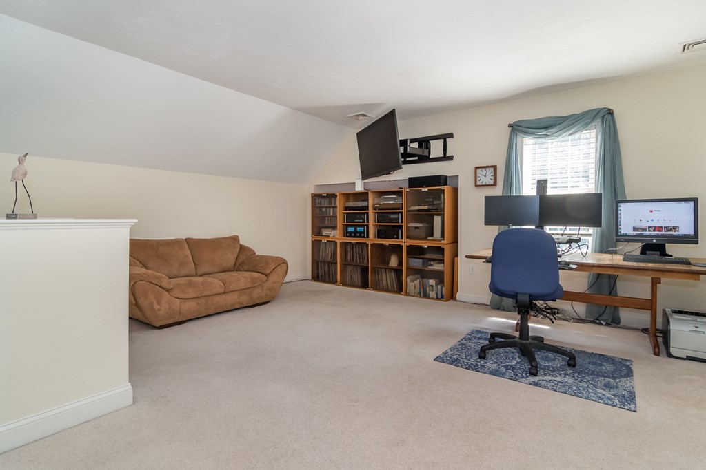28 Prestwick Road, Unit 188 Bourne, MA 02532 - Photo 23 of 41 a living room with furniture and a lamp