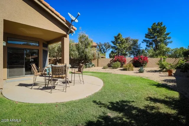 a view of a house with backyard porch and sitting area
