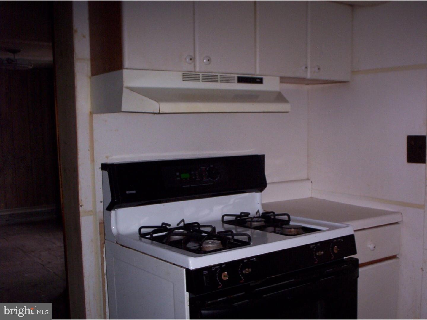 227 Ridge Road Browns Mills, NJ 08015 - Photo 6 of 17 a stove top oven sitting inside of a kitchen