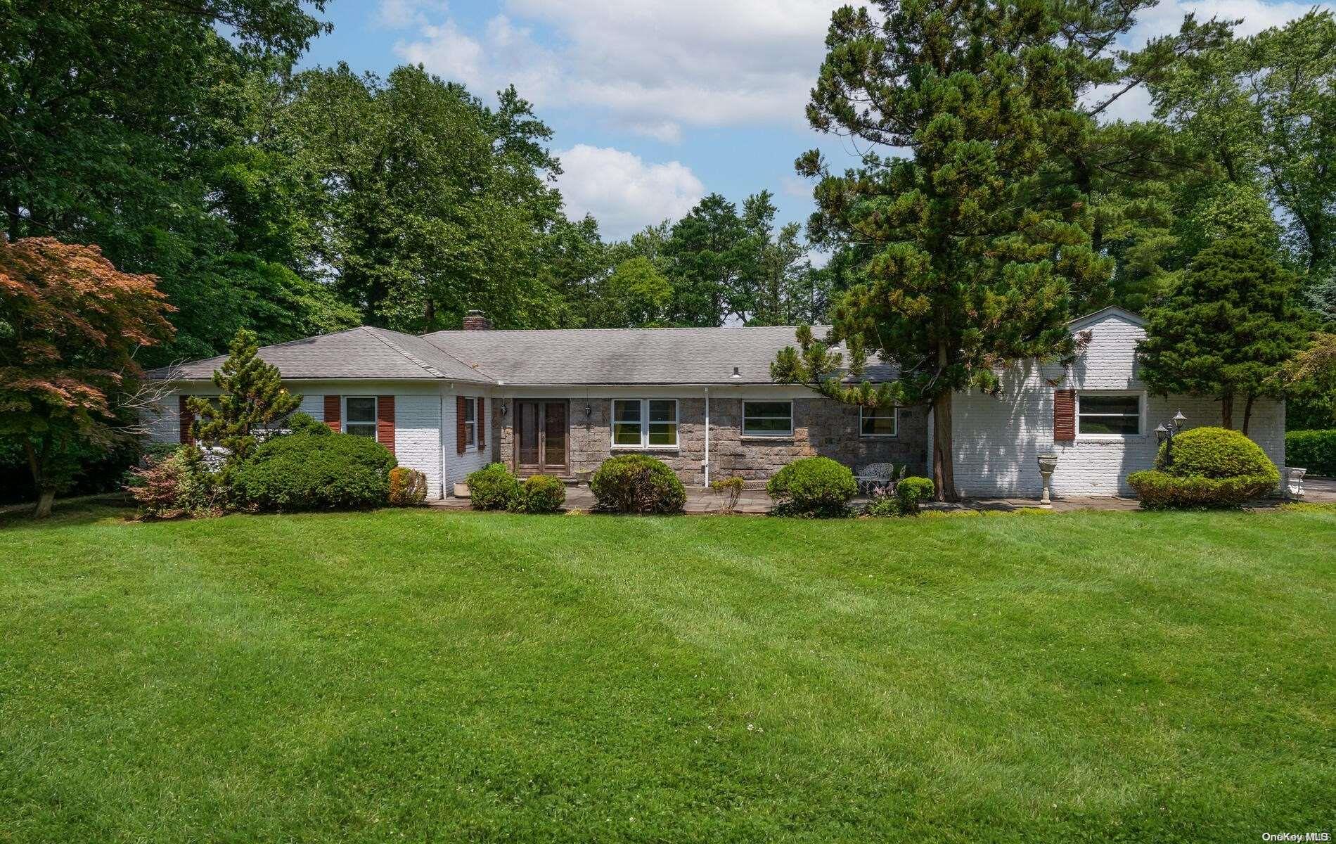 21 Middle Road Sands Point, NY 11050 - Photo 1 of 1 a front view of a house with a yard and trees
