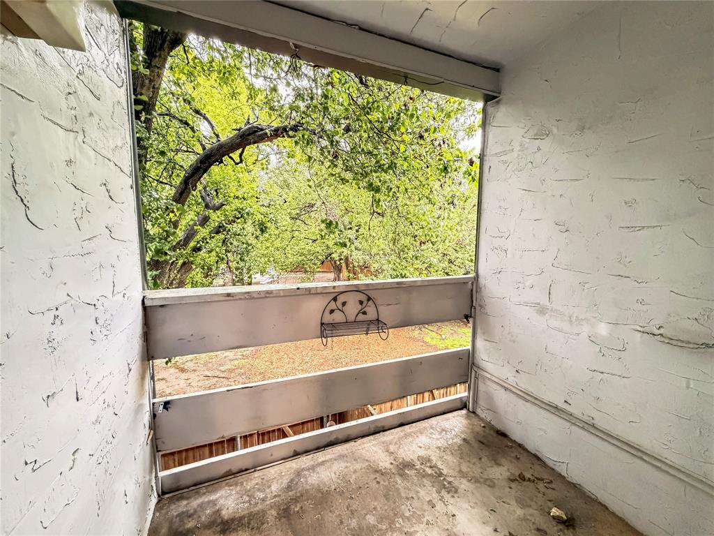 5840 Spring Valley Road, Unit 602 Dallas, TX 75254 - Photo 18 of 19 Outdoor balcony with a stucco-textured wall and a painted wood railing