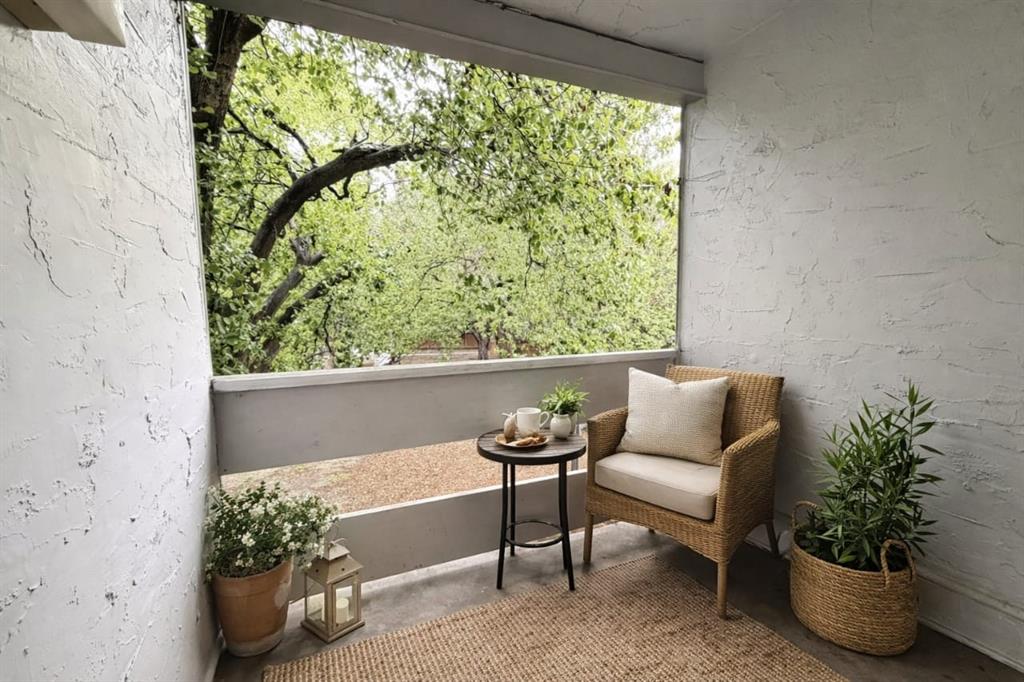 5840 Spring Valley Road, Unit 602 Dallas, TX 75254 - Photo 19 of 19 Private outdoor patio featuring textured white walls and a light-colored railing