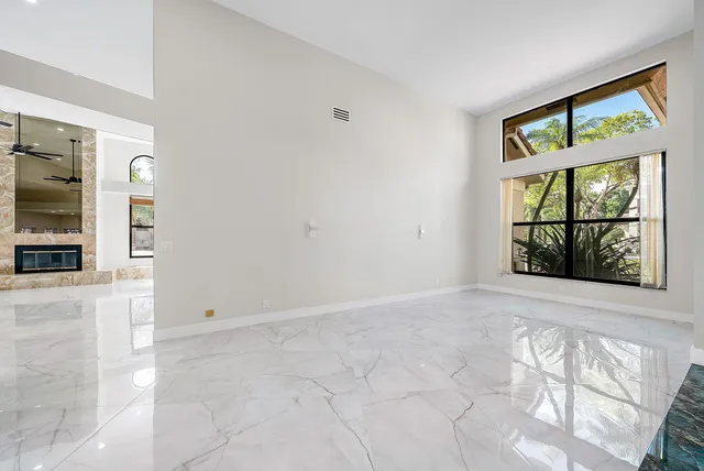 an empty room with windows and entrance