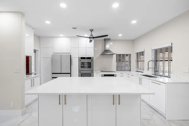 a kitchen with stainless steel appliances a sink and a refrigerator