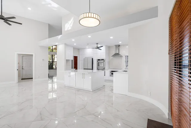 a view of a kitchen with kitchen island and stainless steel appliances