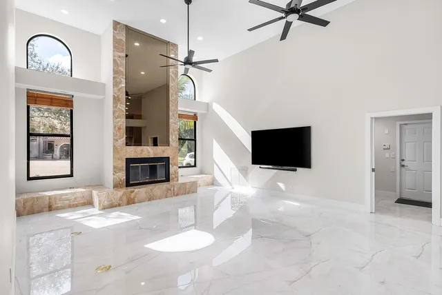 a living room with fireplace furniture and a flat screen tv