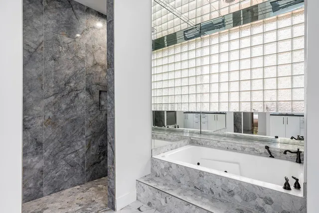 a bathroom with a bathtub and a shower