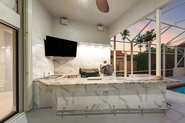 a living room with granite countertop furniture and flat screen tv