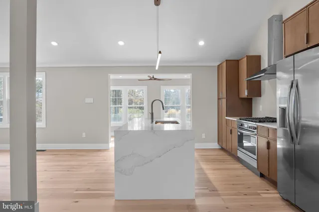 a kitchen with sink cabinets and wooden floor