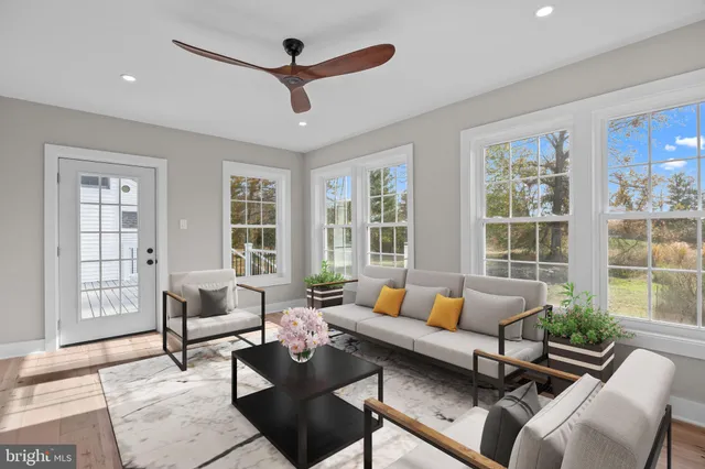 a view of an empty room with a window and a ceiling fan
