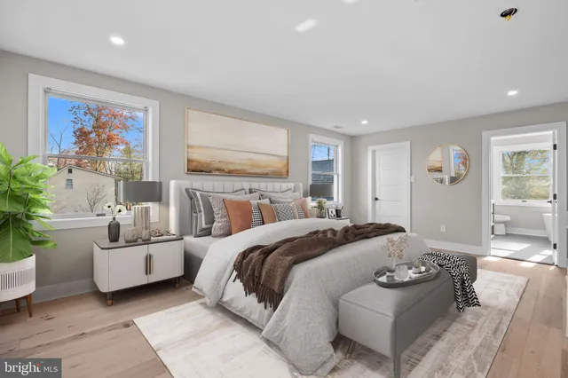 a bathroom with a granite countertop sink toilet and a large mirror