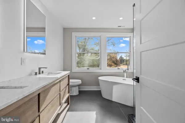 a view of a bathroom with a tub shower and sink