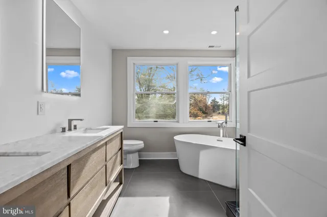 a view of a bathroom with a tub shower and sink