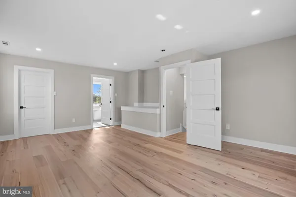 a view of hallway with wooden floor