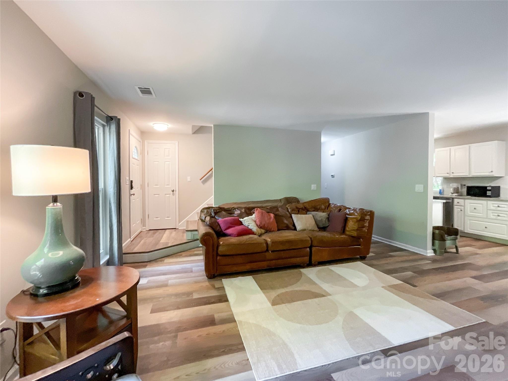 2113 Killarney Place Charlotte, NC 28262 - Photo 4 of 19 a living room with furniture and a lamp