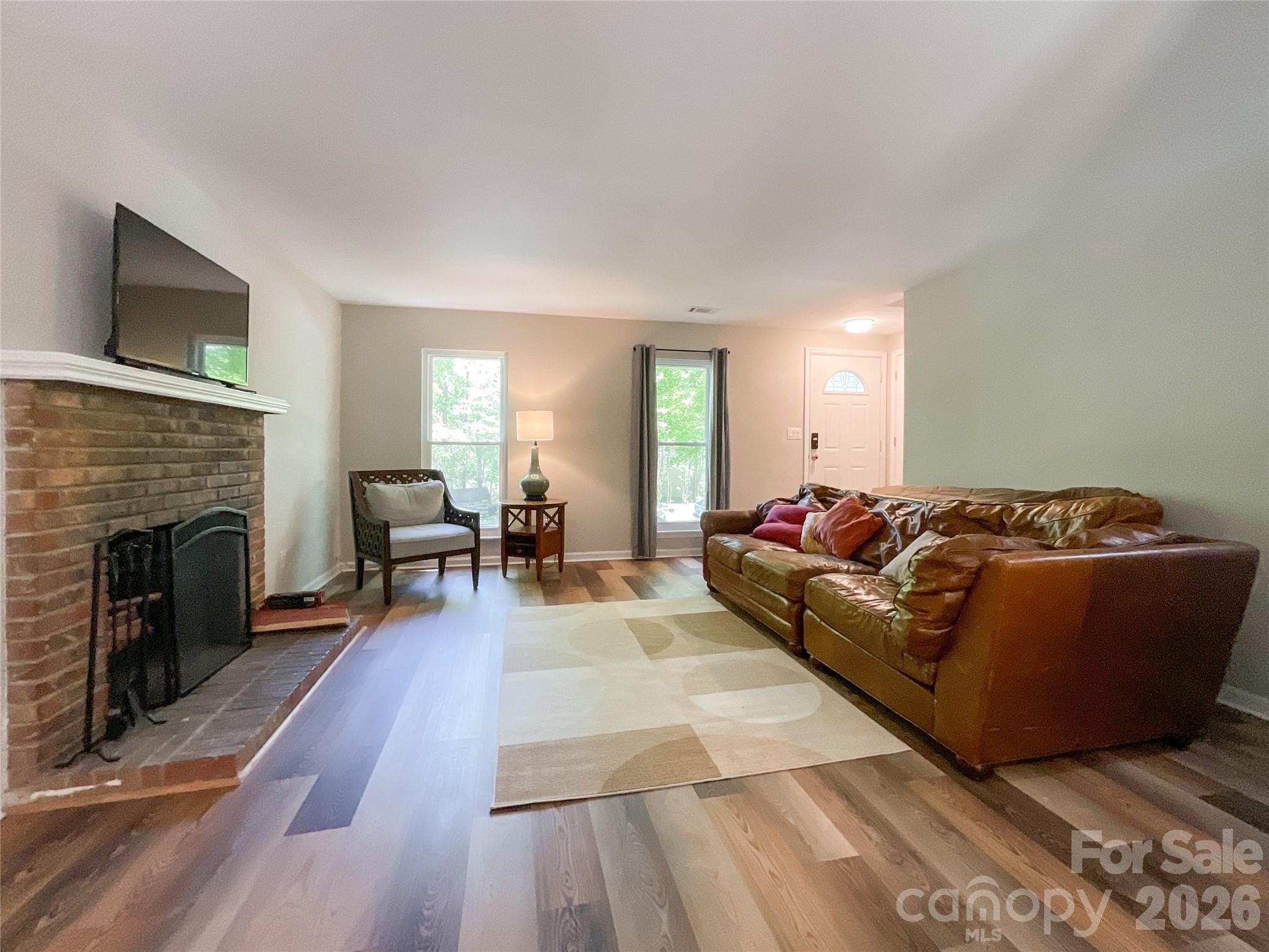 2113 Killarney Place Charlotte, NC 28262 - Photo 5 of 19 a living room with furniture and a fireplace