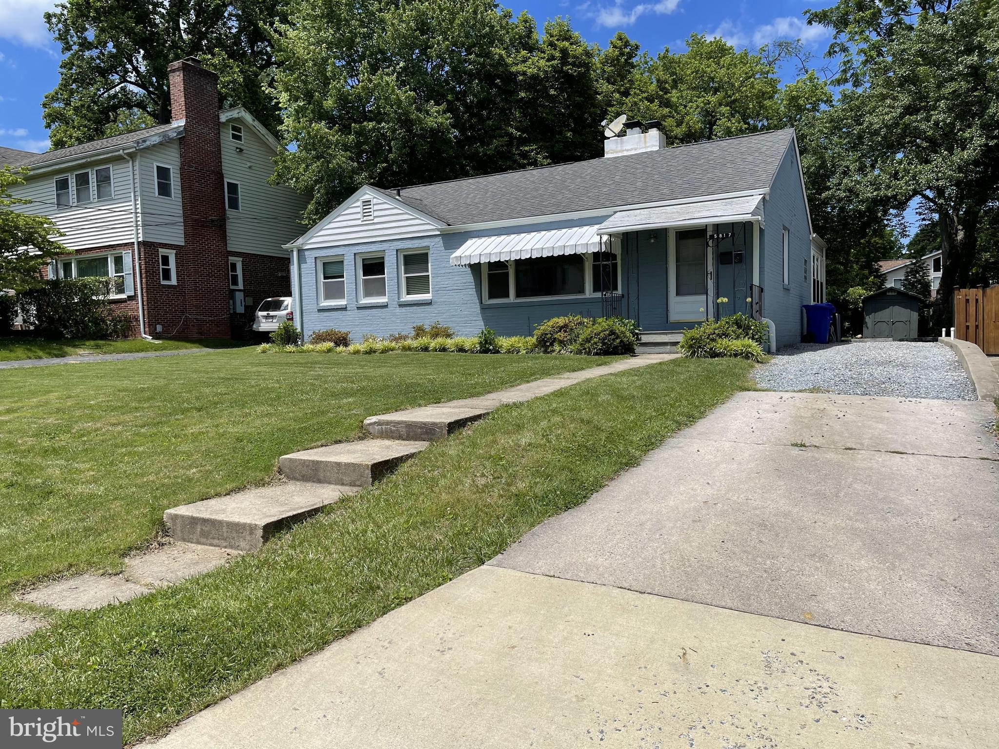 a front view of a house with a garden and porch