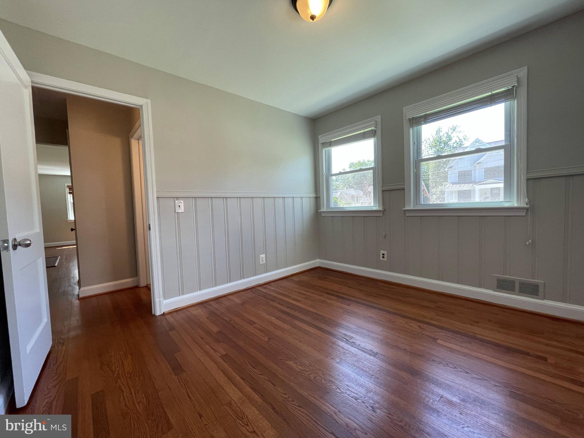 5817 Kingswood Road Bethesda, MD 20814 - Photo 15 of 40 an empty room with wooden floor and windows