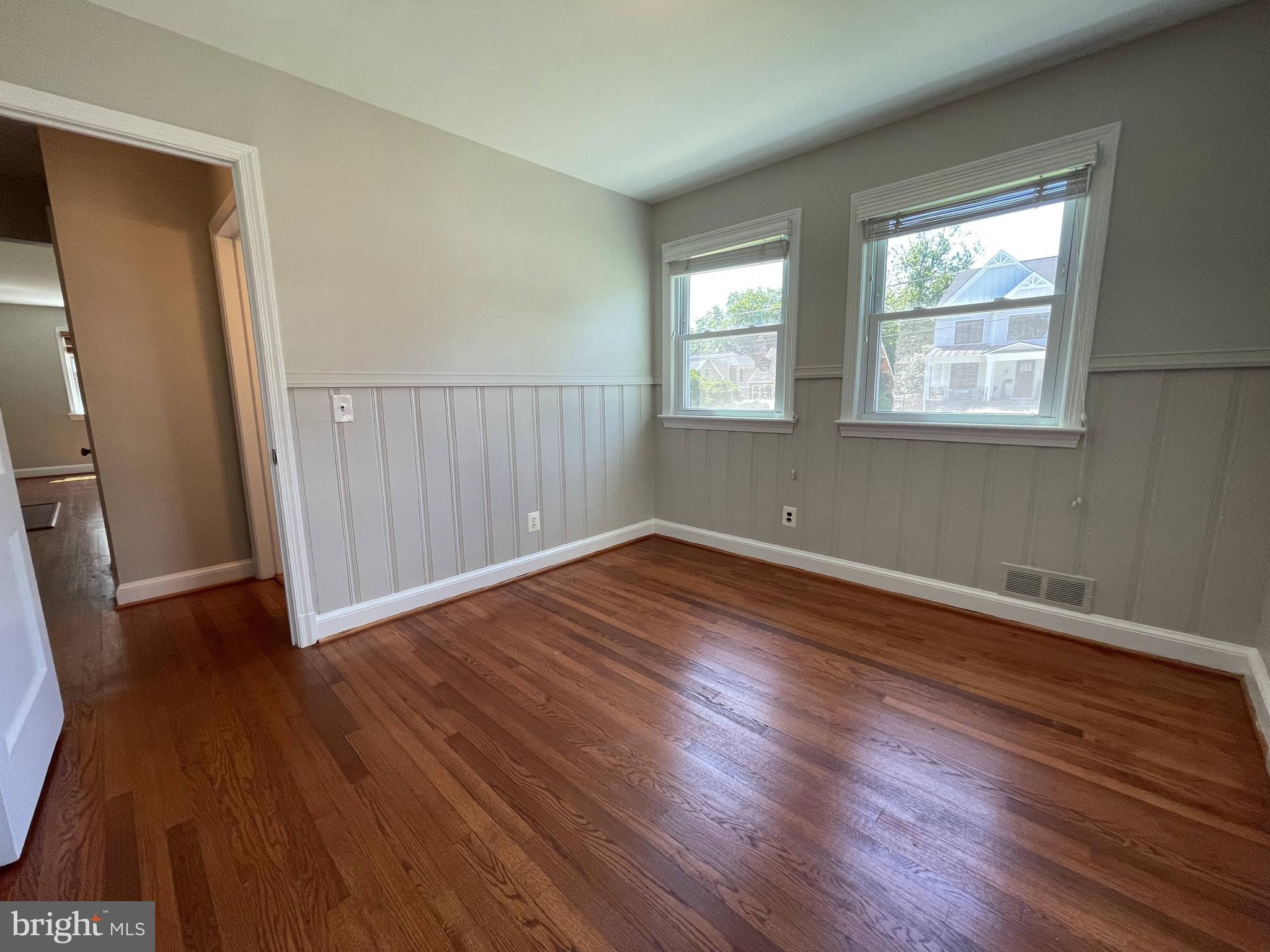 5817 Kingswood Road Bethesda, MD 20814 - Photo 17 of 40 an empty room with wooden floor and windows