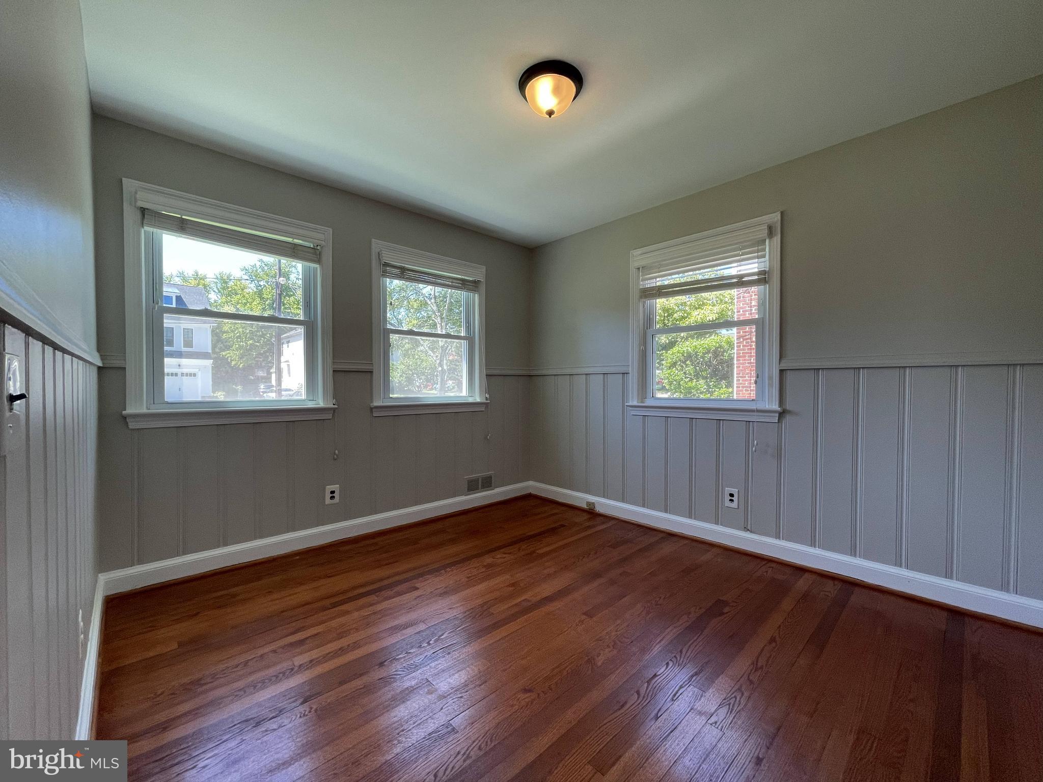 5817 Kingswood Road Bethesda, MD 20814 - Photo 18 of 40 an empty room with wooden floor and windows