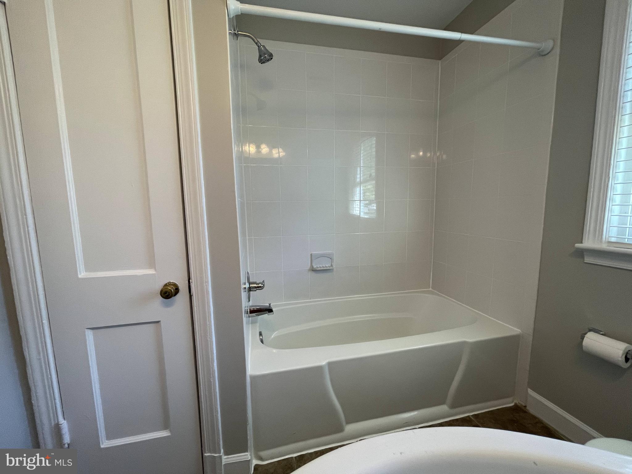 5817 Kingswood Road Bethesda, MD 20814 - Photo 20 of 40 a bathroom with a bathtub and a shower