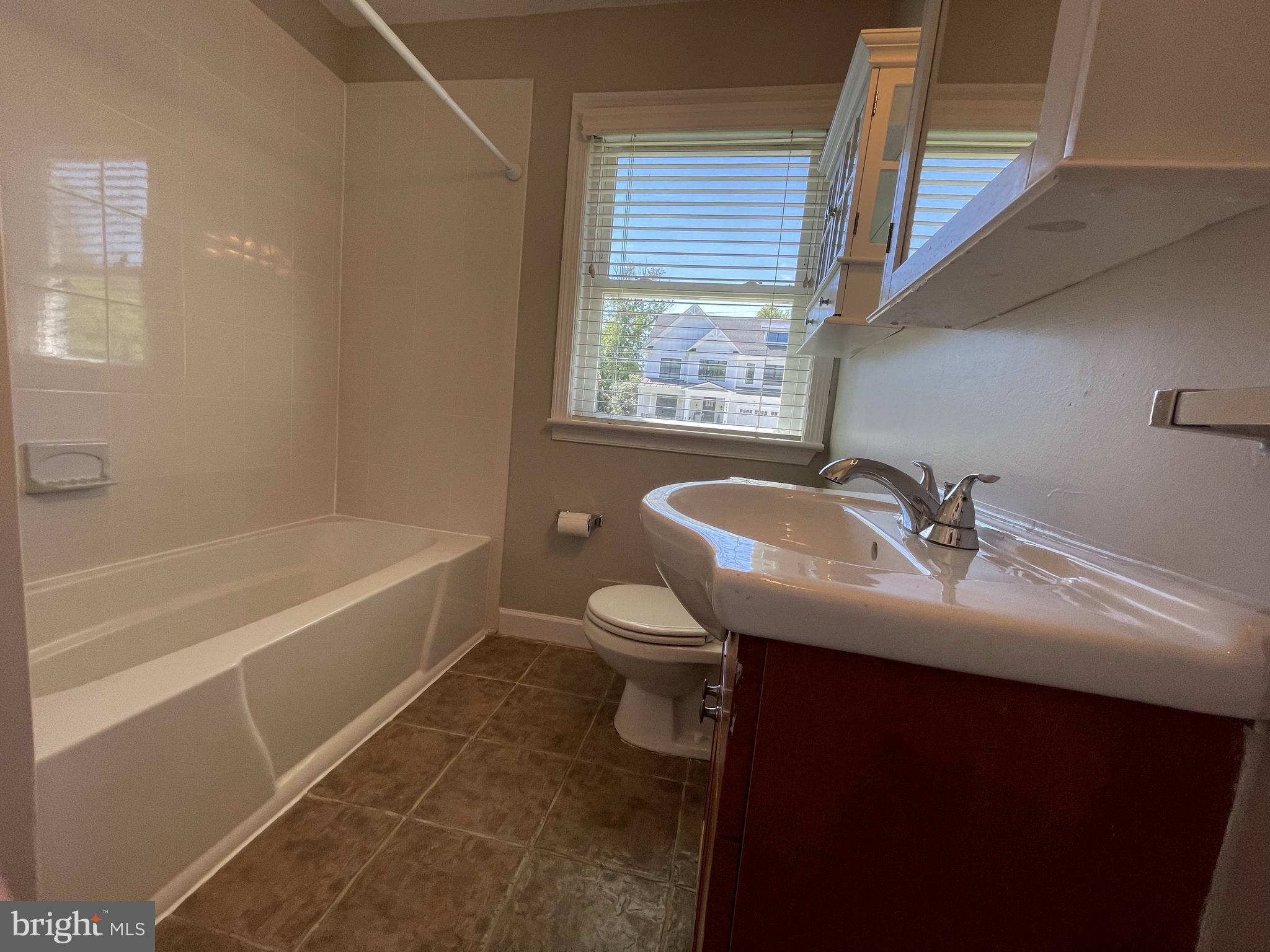 5817 Kingswood Road Bethesda, MD 20814 - Photo 22 of 40 a bathroom with a sink a toilet and a bathtub