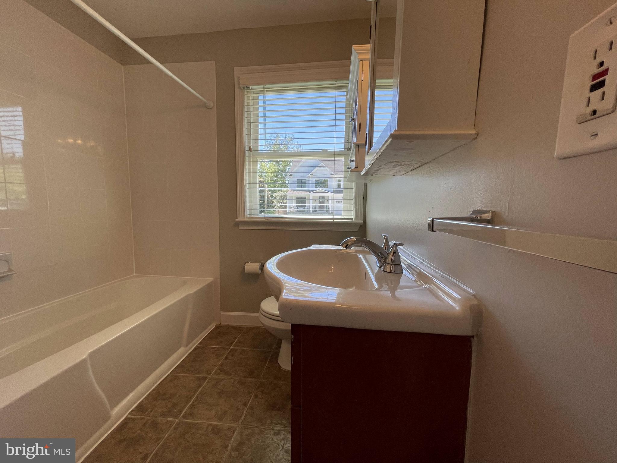5817 Kingswood Road Bethesda, MD 20814 - Photo 23 of 40 a bathroom with a sink a bathtub and a shower