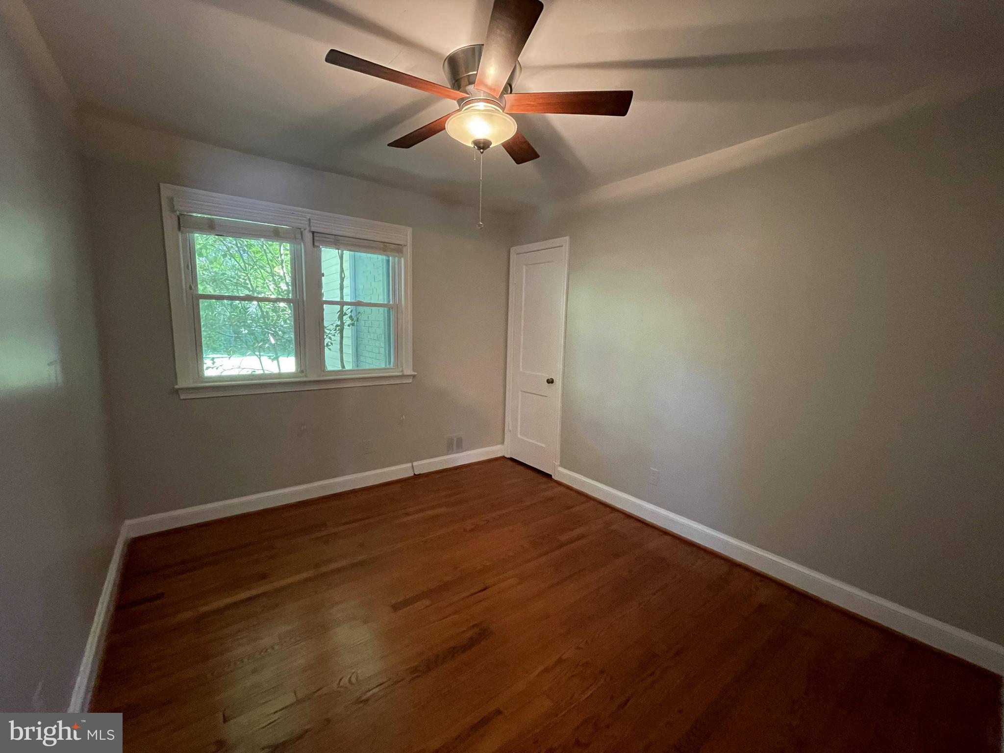5817 Kingswood Road Bethesda, MD 20814 - Photo 25 of 40 a view of an empty room with window and chandelier fan