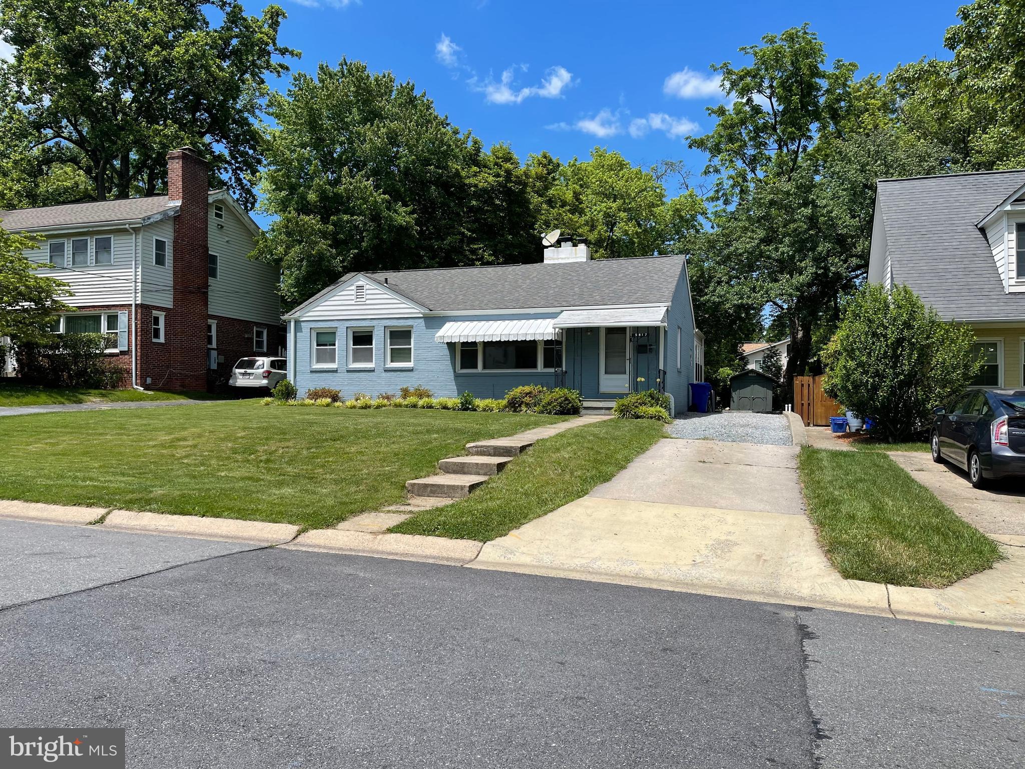 5817 Kingswood Road Bethesda, MD 20814 - Photo 4 of 40 a front view of a house with a yard and garage