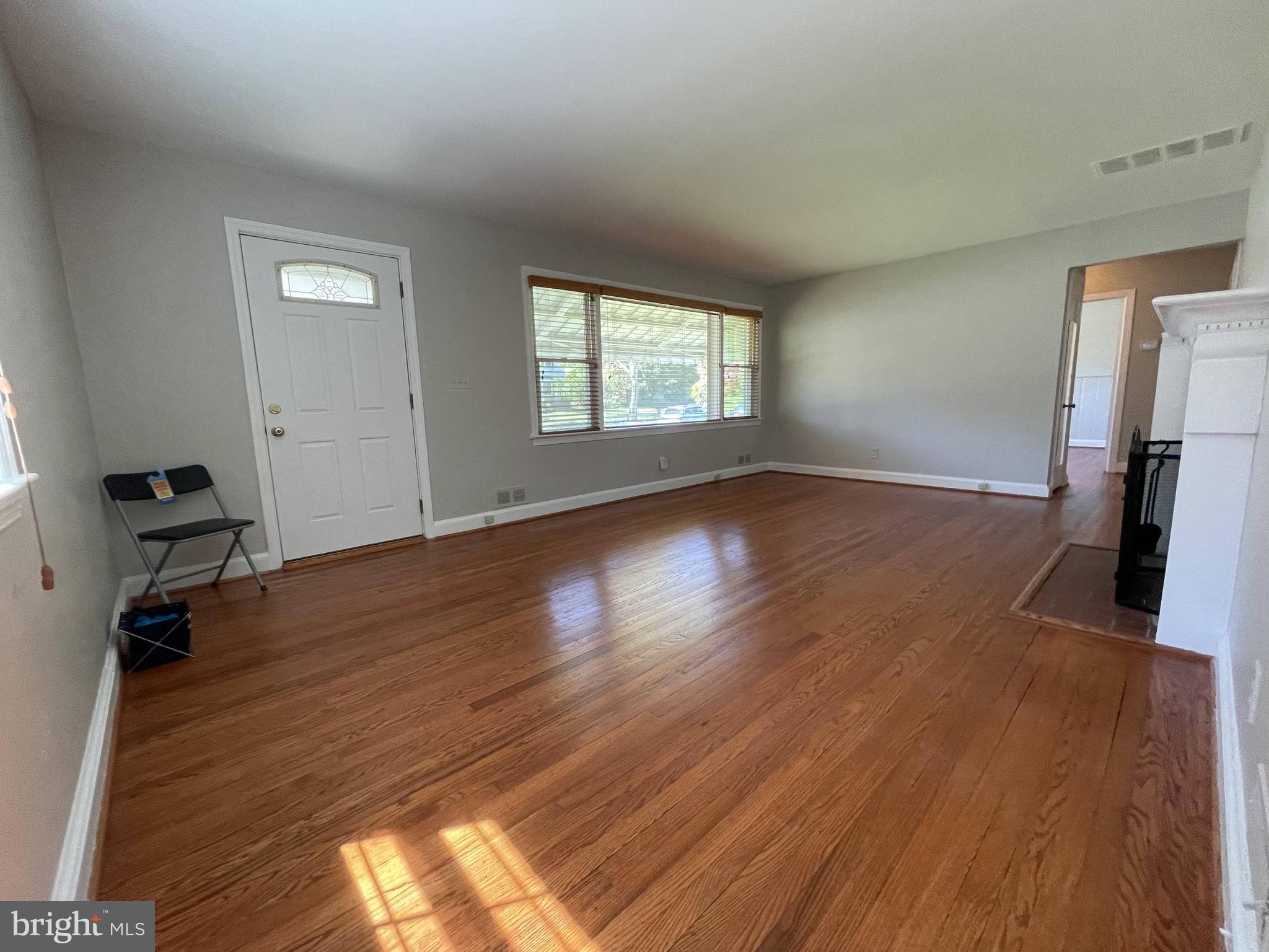 5817 Kingswood Road Bethesda, MD 20814 - Photo 9 of 40 a view of a livingroom with wooden floor and a window