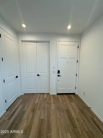 a view of an empty room with wooden floor