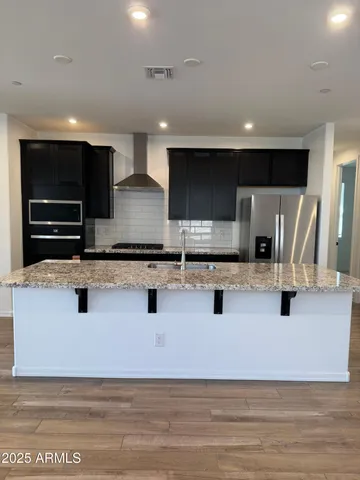 a kitchen with stainless steel appliances a sink and a refrigerator