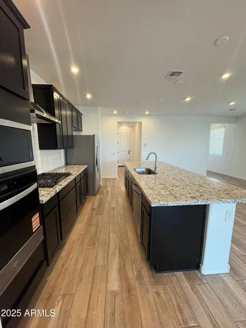 a kitchen with stainless steel appliances granite countertop a stove and a sink