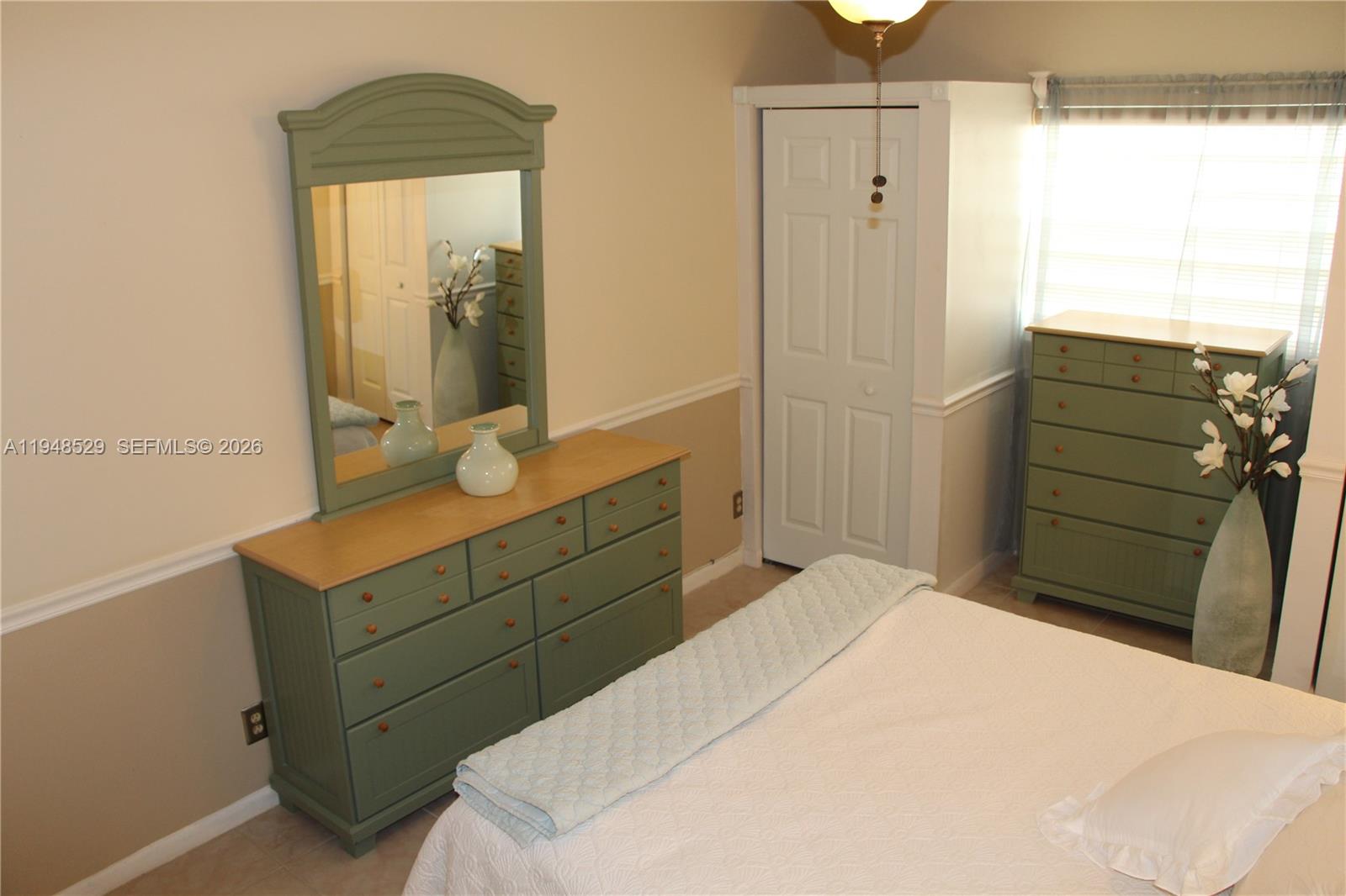 5620 Southwest 3rd Place, Unit 114 Margate, FL 33068 - Photo 14 of 29 a bedroom with a bed and a mirror