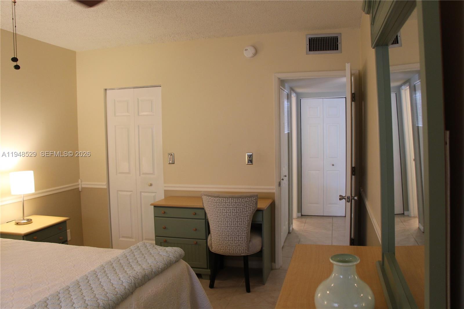 5620 Southwest 3rd Place, Unit 114 Margate, FL 33068 - Photo 15 of 29 a bedroom with a bed and a chair