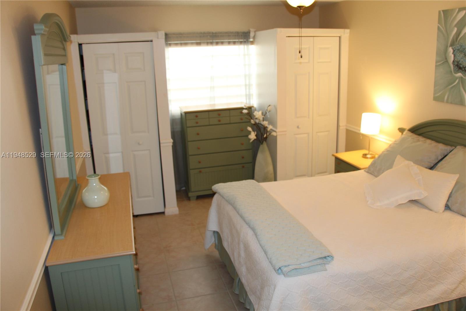 5620 Southwest 3rd Place, Unit 114 Margate, FL 33068 - Photo 17 of 29 a bedroom with a bed and wooden floor