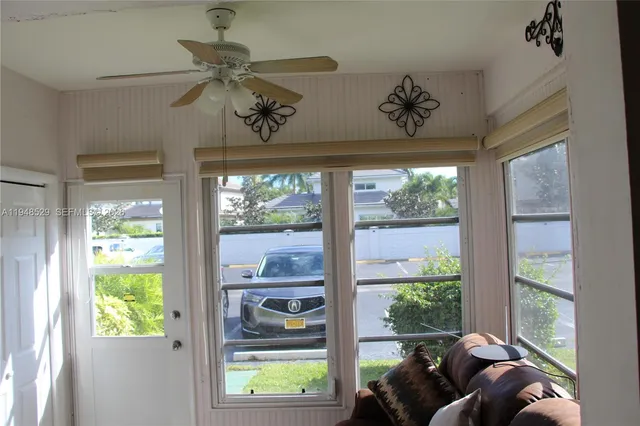 a view of a livingroom with a window and furniture