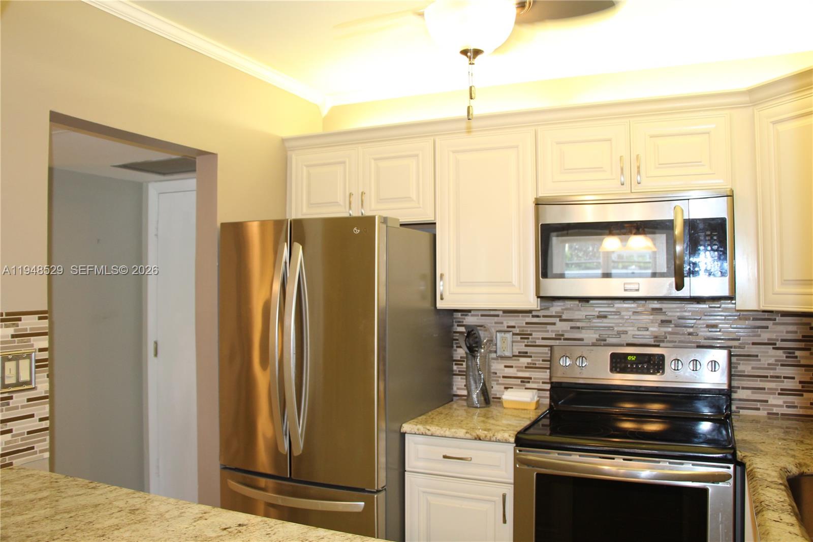 5620 Southwest 3rd Place, Unit 114 Margate, FL 33068 - Photo 5 of 29 a kitchen with a stove and a refrigerator