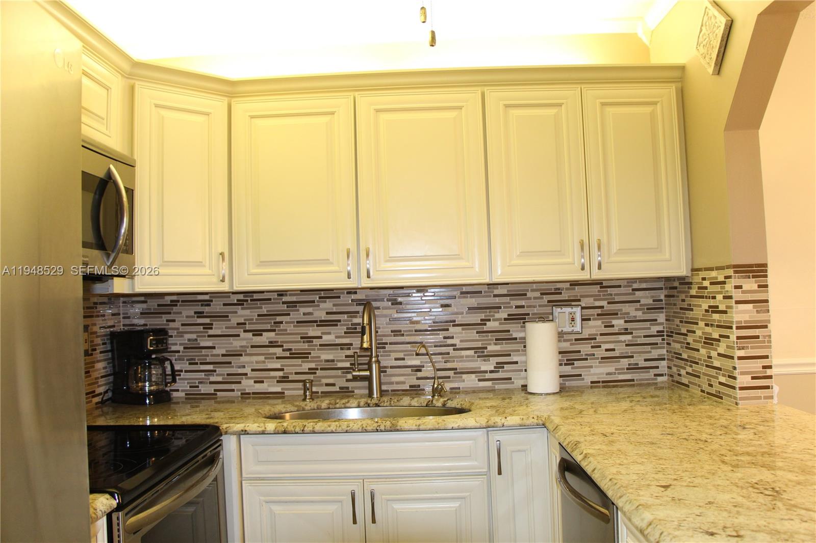 5620 Southwest 3rd Place, Unit 114 Margate, FL 33068 - Photo 6 of 29 a kitchen with a sink and cabinets