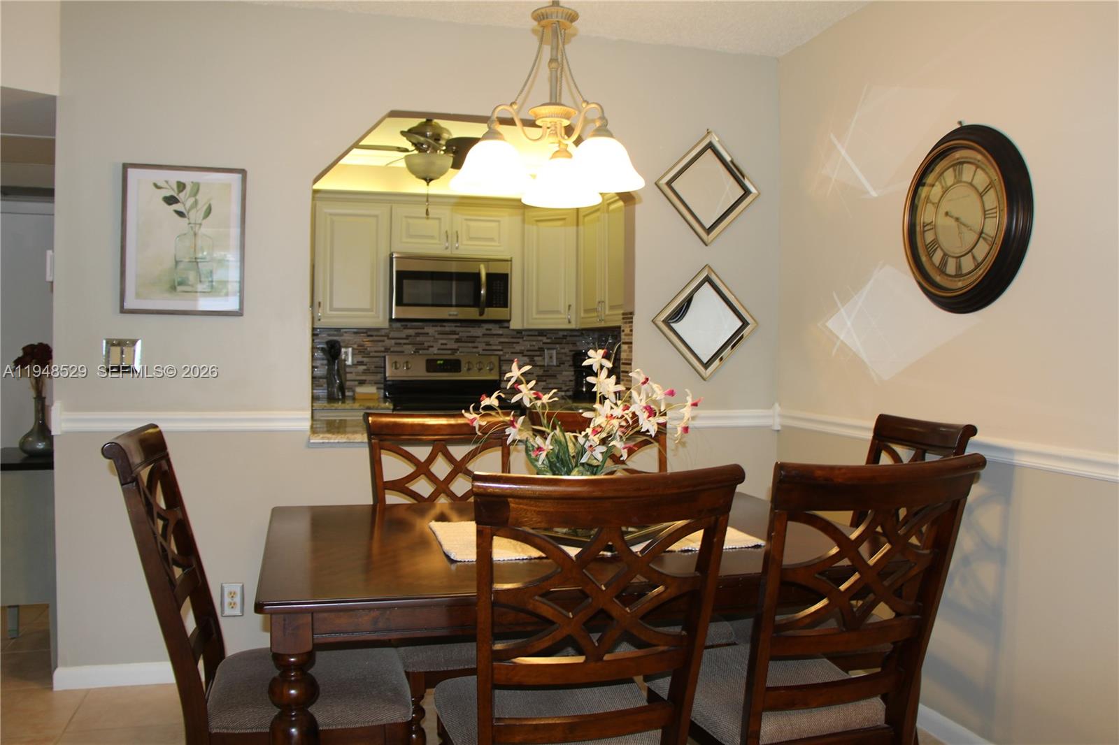 5620 Southwest 3rd Place, Unit 114 Margate, FL 33068 - Photo 7 of 29 a view of a dining room with furniture and a chandelier