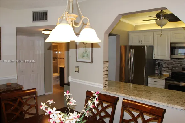 a kitchen with a table and refrigerator