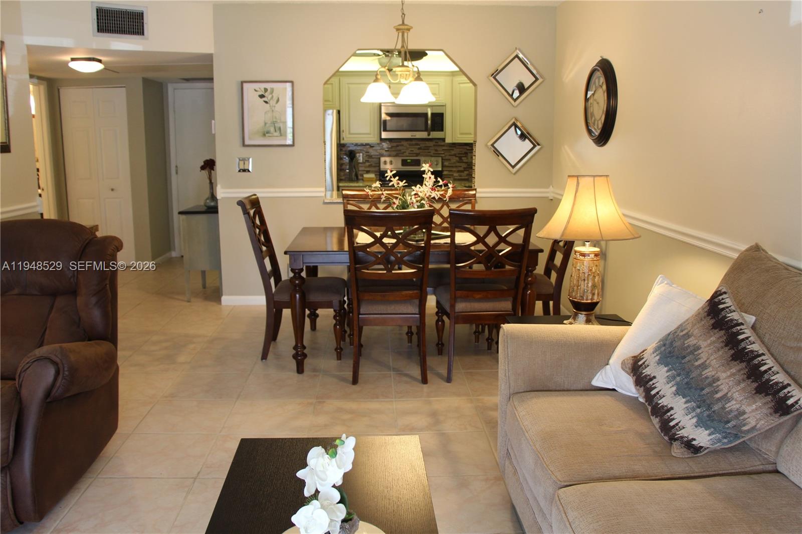 5620 Southwest 3rd Place, Unit 114 Margate, FL 33068 - Photo 9 of 29 a view of a dining room with furniture and chandelier