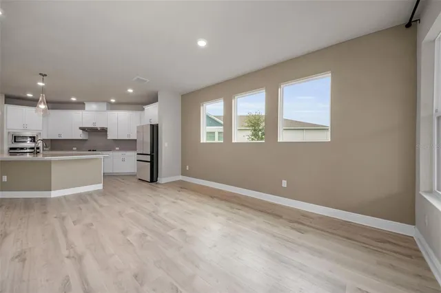 a view of kitchen with wooden floor and windows