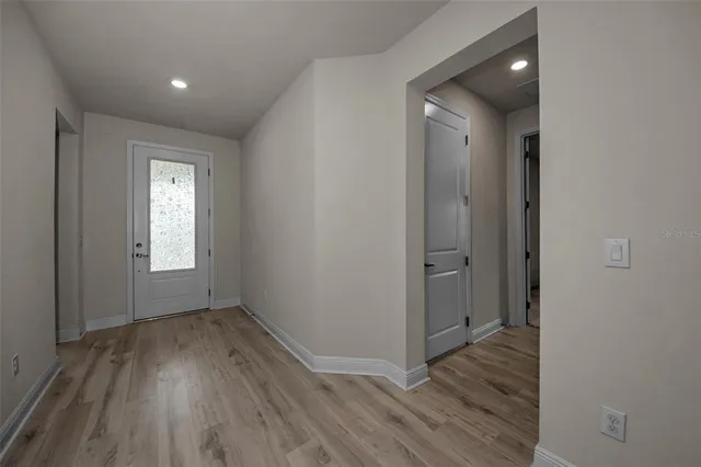 a view of a room with wooden floor and window