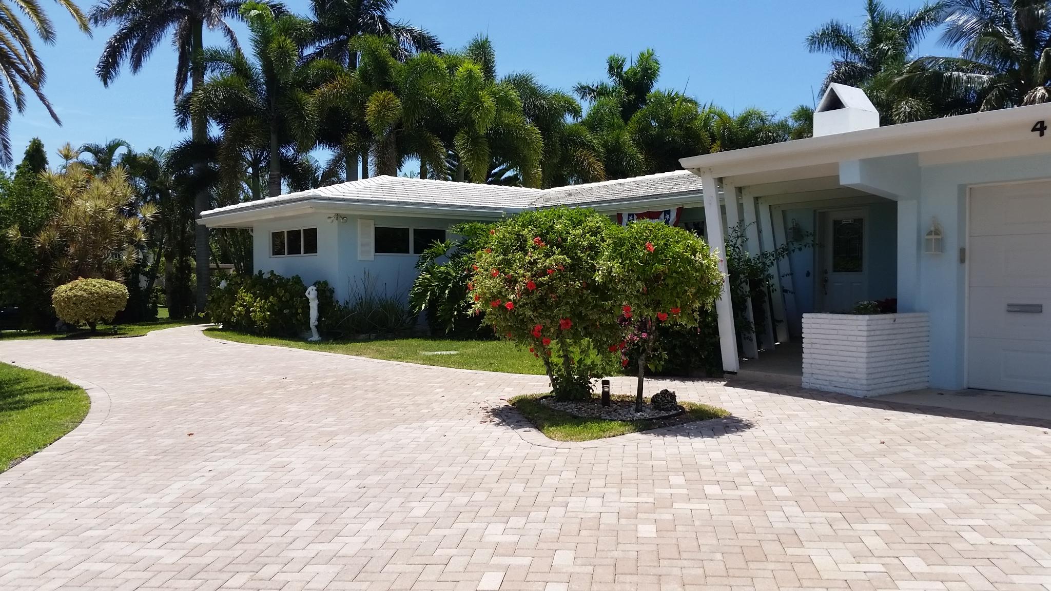 498 Northeast 37th Street Boca Raton, FL 33431 - Photo 3 of 29 a view of a house with potted plants and a yard