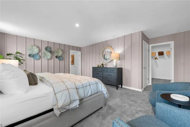 a bedroom with bed and a large window