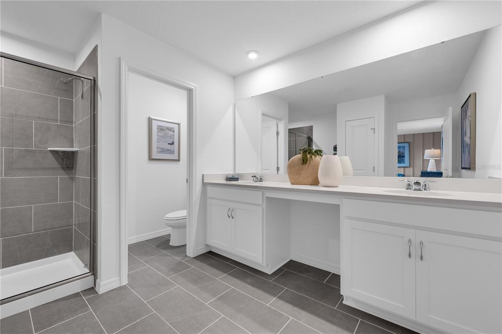 643 Rockaway Lane Cocoa, FL 32927 - Photo 20 of 34 a spacious bathroom with a double vanity sink a mirror and a shower
